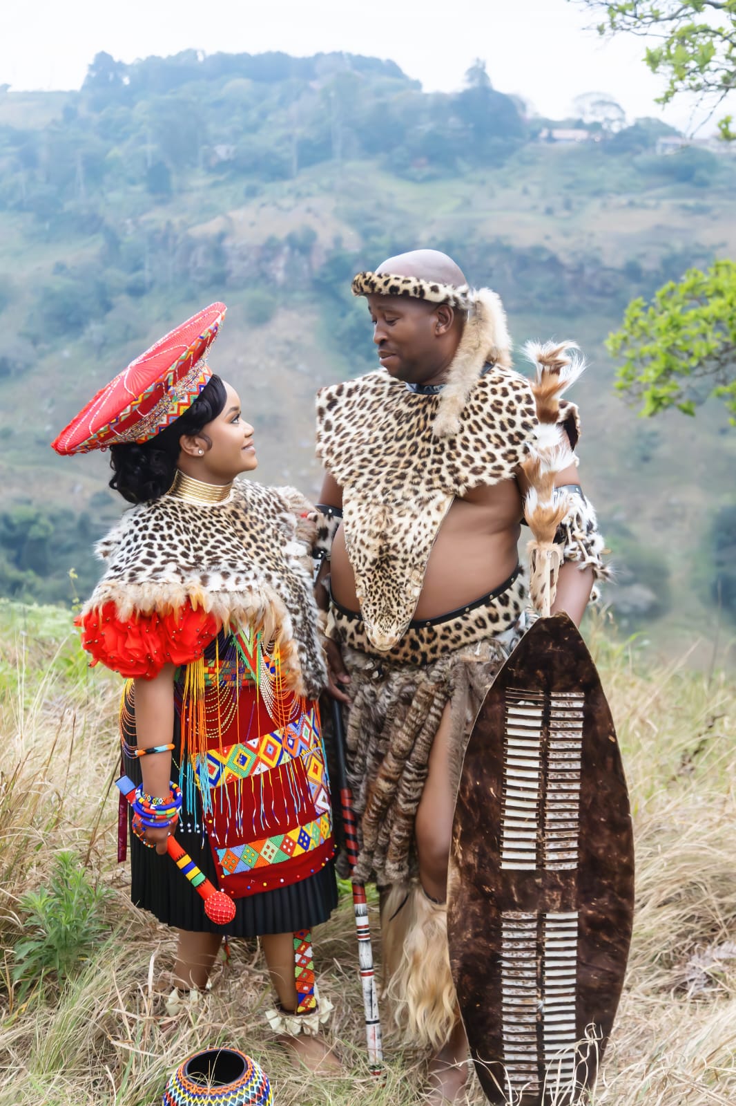 The couple outdoors in traditional attire